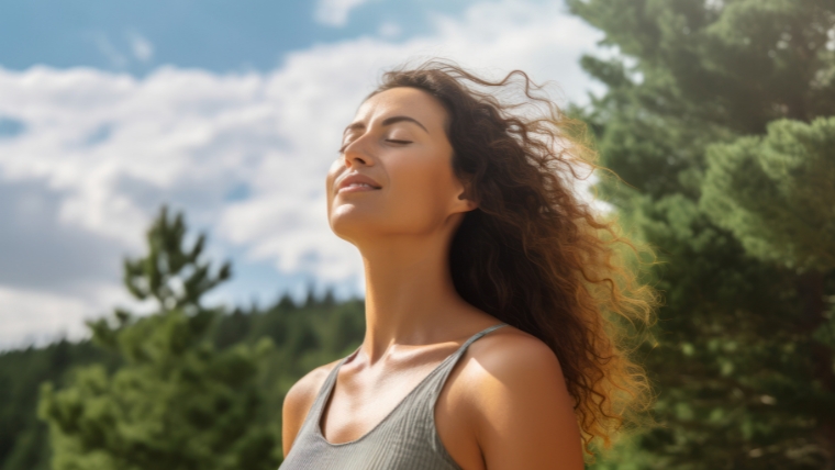 Relaxed caucasian woman breathing fresh air in a green forest. | Mindfulness Techniques for Bipolar Disorder Do They Actually Help | Mindful Health Solutions