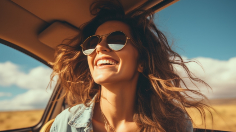 Caucasian woman in a car with sunglasses on, smiling with sun on face and hair in wind | No More Stress Why Boundaries Are Your New Anxiety-Busting Tool | Mindful Health Solutions
