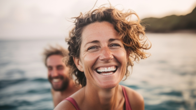 A smiling woman in the water with friends | Busting the Top 5 Myths and Misconceptions about Esketamine Therapy | Mindful Health Solutions