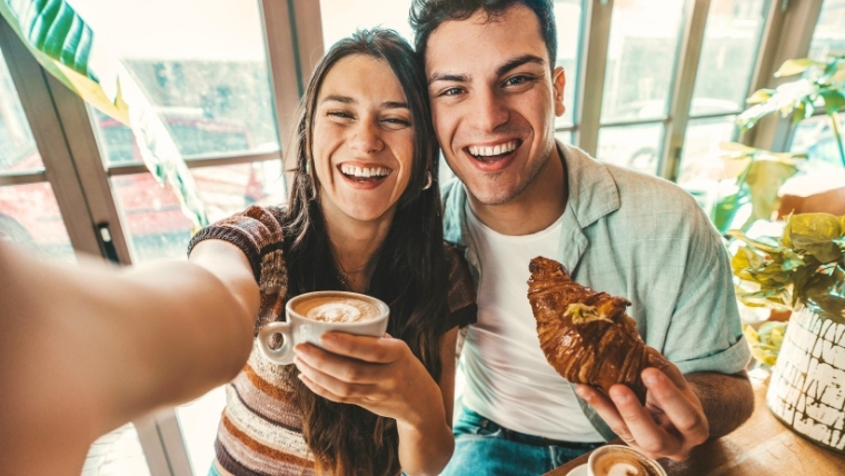 Happy couple on a breakfast date drinking coffee at bar cafeteria | Anxiety and Dating: 10 Expert Tips to Stay Calm and Confident | Mindful Health Solutions