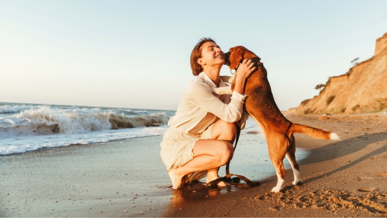 A woman on the beach with her dog | Cultivate Happiness: How to Unlock the Power of Mindful Appreciation | Mindful Health Solutions