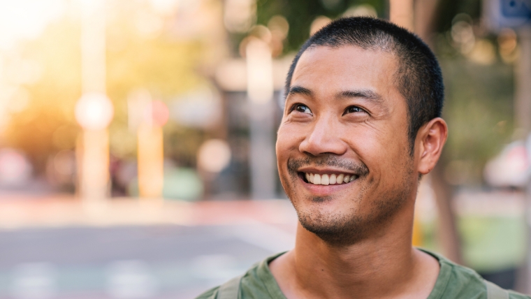 A smiling man on a city street | SPRAVATO Safety: Separating Fact from Fiction for Informed Decisions | Mindful Health Solutions